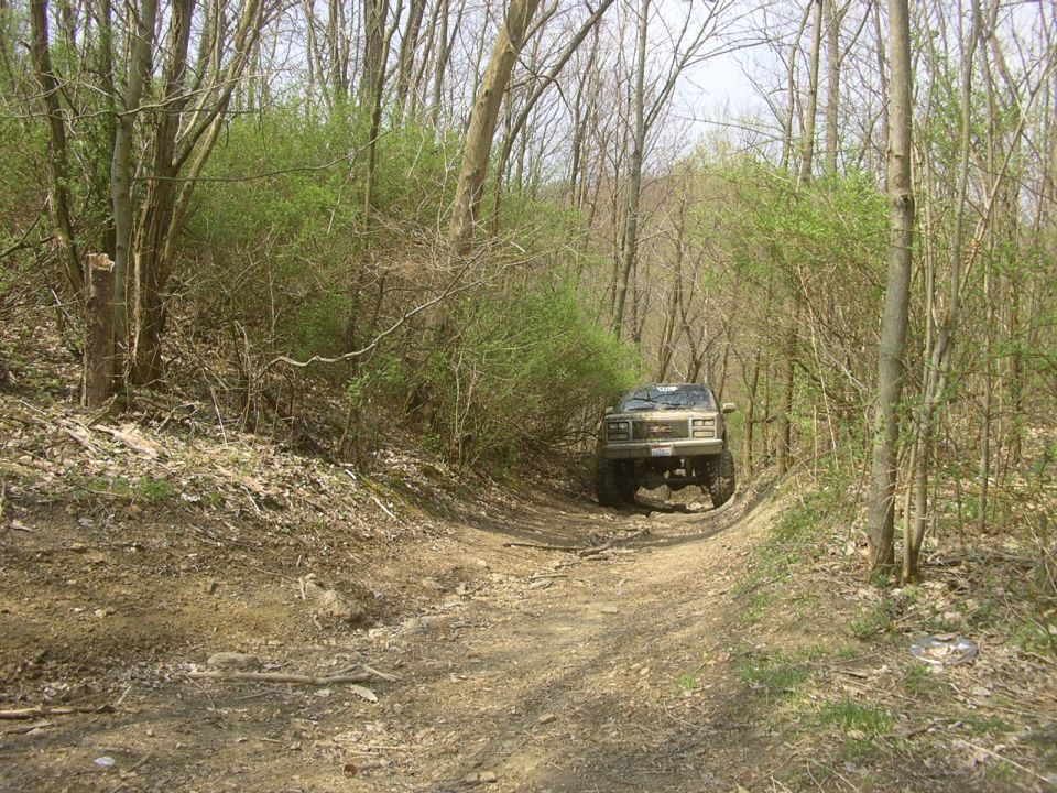 1989 GMC Jimmy on dirt road in woods