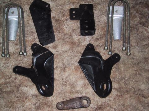1990 Ford Bronco - A collection of assorted vehicle suspension components are displayed on a textured background.