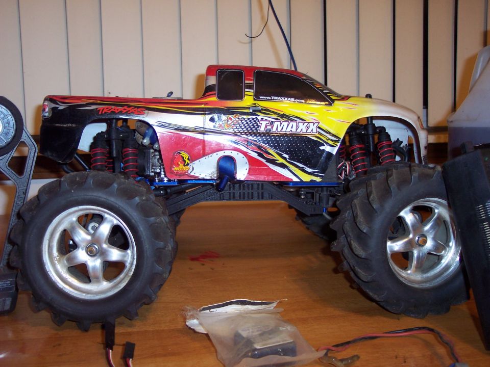 Traxxas T-Maxx remote control monster truck with colorful graphics, side view