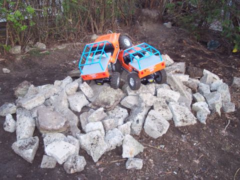 1974 Ford Bronco - Two toy trucks are shown in a rocky outdoor scene.