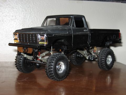 1977 Ford F-150 - This model truck appears to be a 1977 Ford F-150, a lifted suspension and custom wheels.