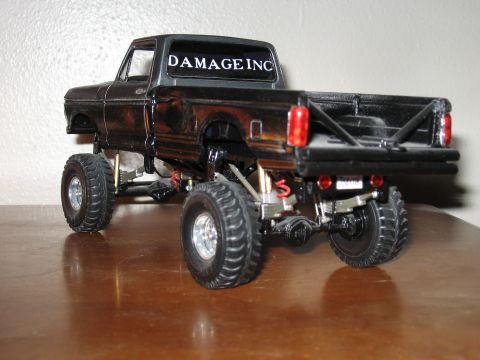 1977 Ford F-150 - Model truck with custom modifications, including a lifted suspension and off-road tires.