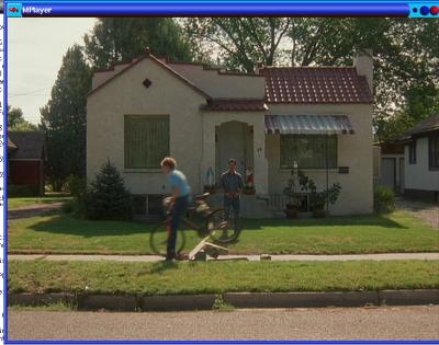 1977 Ford F-150 - A suburban scene unfolds with two individuals and a bicycle on a grassy lawn in front of a house.
