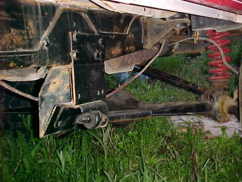 1982 Ford Bronco - Close-up view of the undercarriage of a 1982 Ford Bronco, highlighting the suspension system and frame.