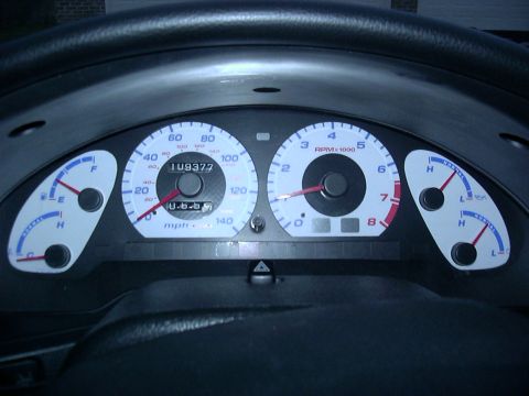 1995 Ford Probe - Close-up of a car's instrument cluster, showing the speedometer, tachometer, and other gauges.