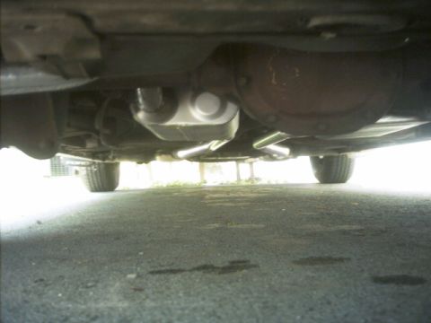 1985 Ford Crown Victoria LTD - The photo shows the underside of a vehicle, focusing on the exhaust system components.