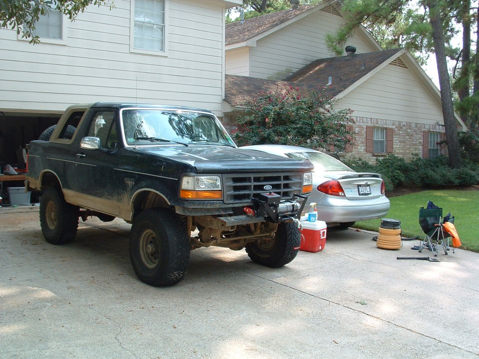 Dark blue 1993 Ford Bronco with winch, lifted suspension, and off-road tires