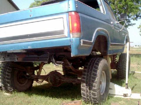 1984 Ford Bronco - Used a floor jack and 4x4 block to raise body on one side to work on frame. Wood blocks placed between body & frame for safety