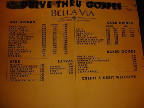 1993 Ford Taurus - This is a menu from Bella Via coffee shop, listing various drinks and baked goods.