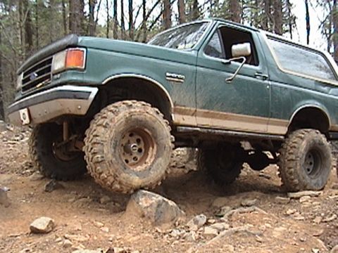 1996 Ford Bronco - This modified Ford Bronco is shown off-roading on a challenging, rocky path.