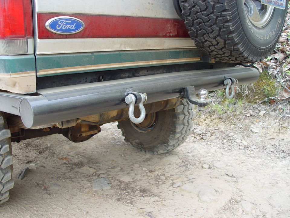 Rear view of a 1996 Ford Bronco showing the spare tire, tow hitch, and aftermarket bumper