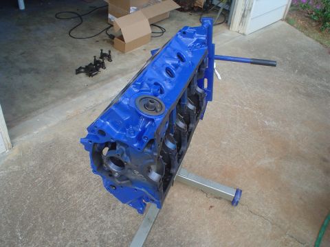 1984 Ford Bronco - Engine block painted blue and mounted on an engine stand.