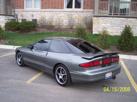 1995 Ford Probe - 1995 Ford Probe in a parking lot. The car has aftermarket wheels and a rear spoiler.