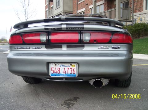 1995 Ford Probe - The rear of a silver 1995 Ford Probe shows off its taillights, spoiler, and a dual exhaust pipe.
