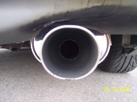 1995 Ford Probe - A close-up view of a vehicle's exhaust pipe and tire, with visible text overlay.