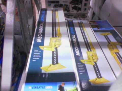 1990 Ford Bronco - Boxes of mechanical lifting jacks are displayed on shelves, with text indicating "VERSATILE USES".