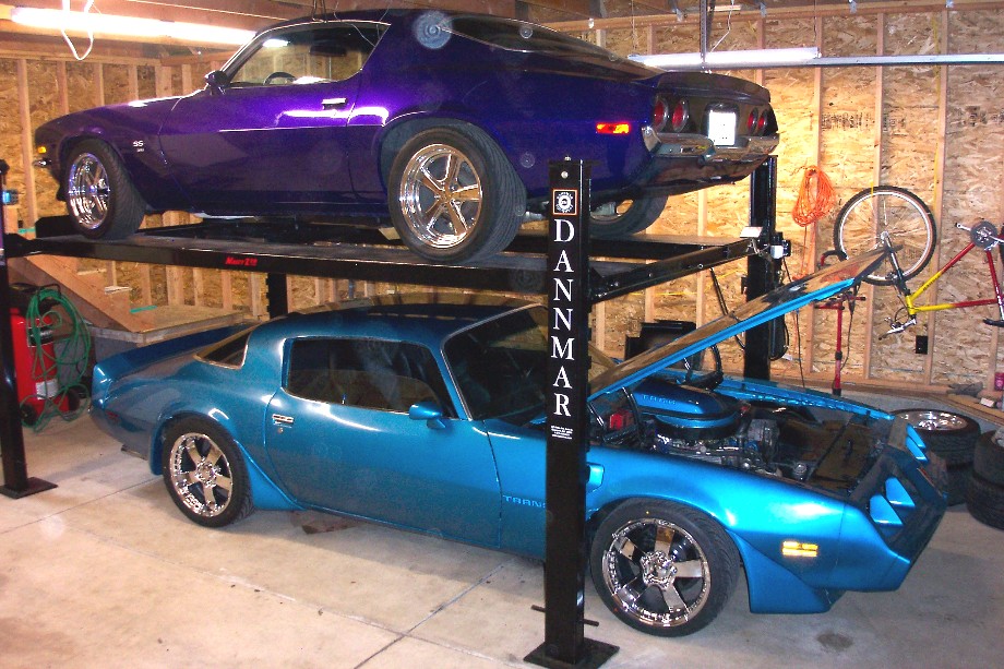 Blue 1979 Pontiac Trans Am with hood open, purple Trans Am above