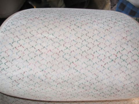 1993 Ford Thunderbird - Close-up of a car's interior seat fabric, showing a repeating diamond pattern.