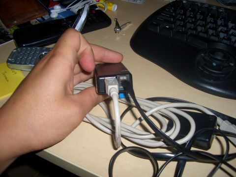 1990 Ford Bronco - A hand connects cables to a USB hub, with a keyboard visible in the background.