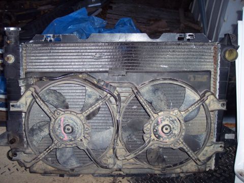 1974 Ford Bronco - This is a radiator assembly two electric fans, likely for a vehicle's cooling system.