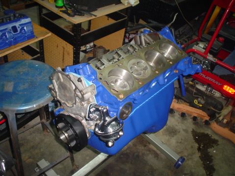 1984 Ford Bronco - A blue engine block, likely a Ford 302, is shown on an engine stand, ready for assembly.