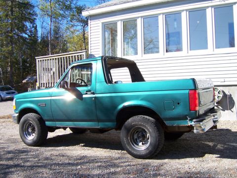 1996 Ford Bronco - This 1996 Ford Bronco is parked outside a house on a sunny day.