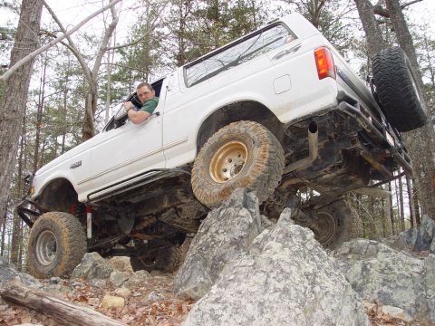 1996 Ford Bronco - This modified Ford Bronco navigates a challenging rocky terrain, its off-road capabilities.