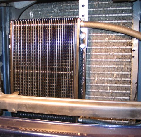 1994 Ford Bronco - Close-up view of a transmission cooler and radiator assembly, showing hoses and mounting hardware.