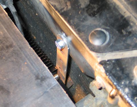 1994 Ford Bronco - Close-up of a metal bracket and bolt, with visible gear teeth in the background.