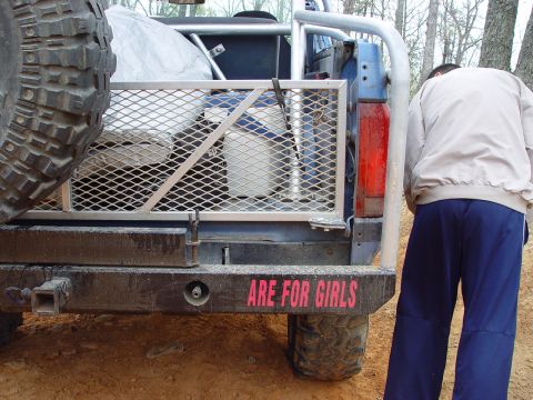 1996 Ford Bronco - This modified SUV features a custom rear rack and a bumper sticker that reads 'ARE FOR GIRLS'.