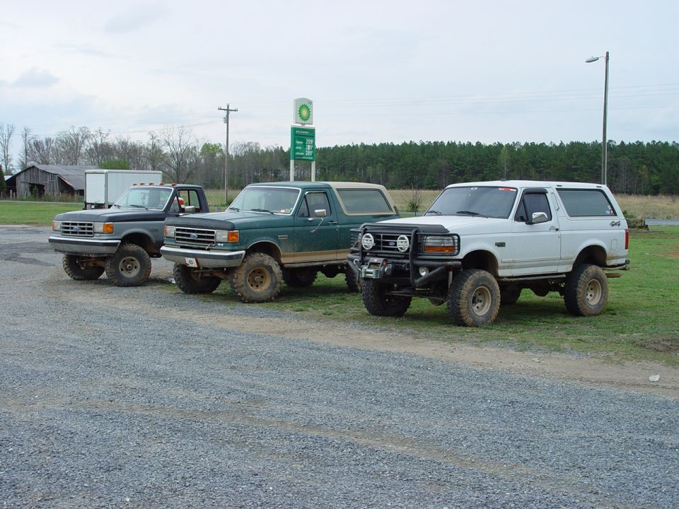 White Ford Bronco with custom bumper and winch parked on gravel