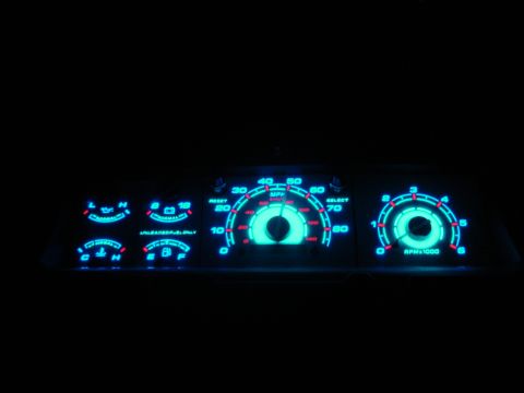 1996 Ford Bronco - The vehicle's dashboard gauges are illuminated with a bright blue glow at night.