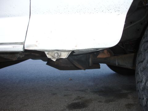 1996 Ford Bronco - Underside view of a vehicle, focusing on the frame and exhaust components.