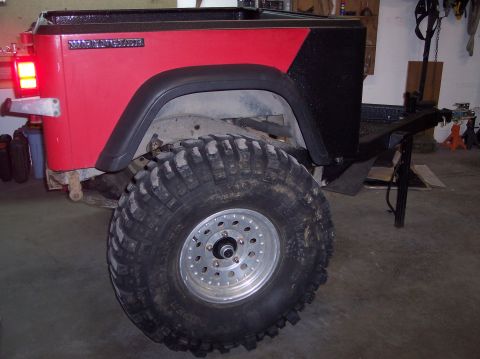 2003 Jeep TJ - Rear view of a 2003 Jeep TJ showing the Wrangler badge and a large off-road tire.