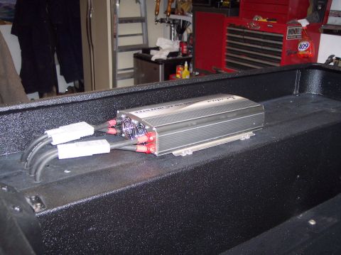 2003 Jeep TJ - A power inverter is shown mounted inside a black box, with cables attached.