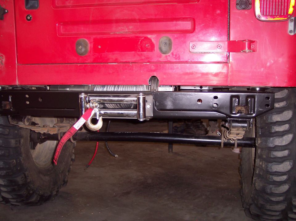 Red Jeep TJ rear bumper with winch and red tow strap. 2003 model