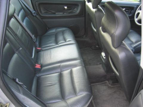1993 Ford Probe - The interior of a car shows black leather rear seats and door panels, with a watermark at the bottom right.