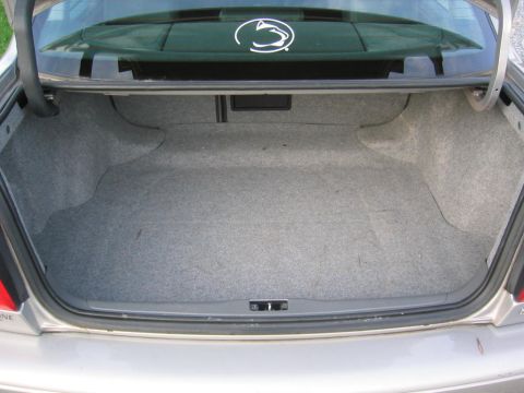 1993 Ford Probe - The interior of a car's trunk is shown, gray carpeting and a Penn State logo on the back window.