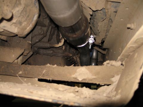 1995 Ford Bronco - Undercarriage view of a vehicle's exhaust system, showing a clamped pipe.