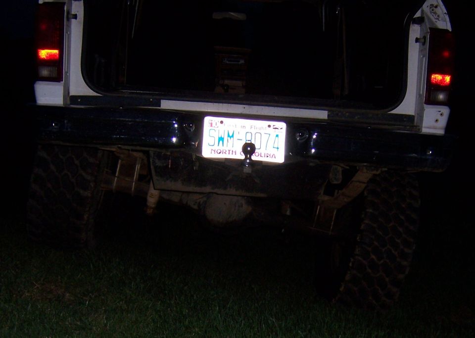 Rear view of a vehicle with a North Carolina license plate SWM-8074 and a tow hitch