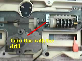 1982 Ford LTD Crown Victoria - Close-up of a door lock or latch mechanism with a red arrow and yellow caption reading Turn this with the drill.