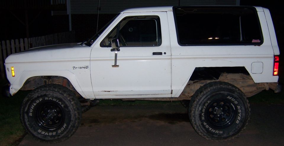 White 1984 Ford Bronco II side view, lifted with off-road tires