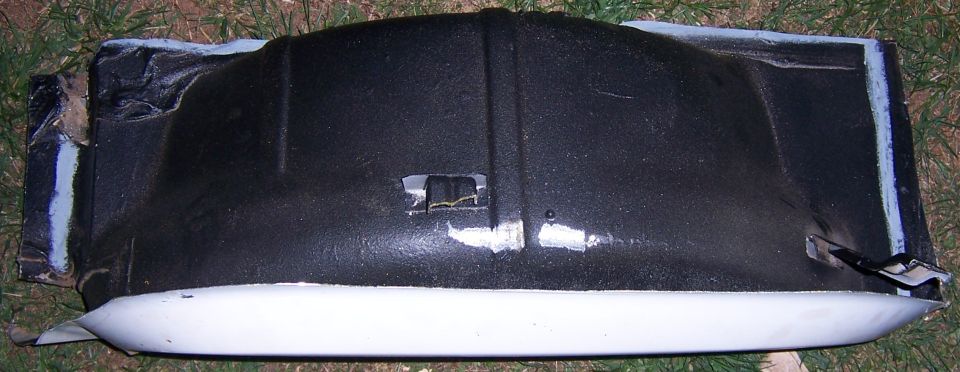Black and white automotive part with visible tape and SuperMotors logo