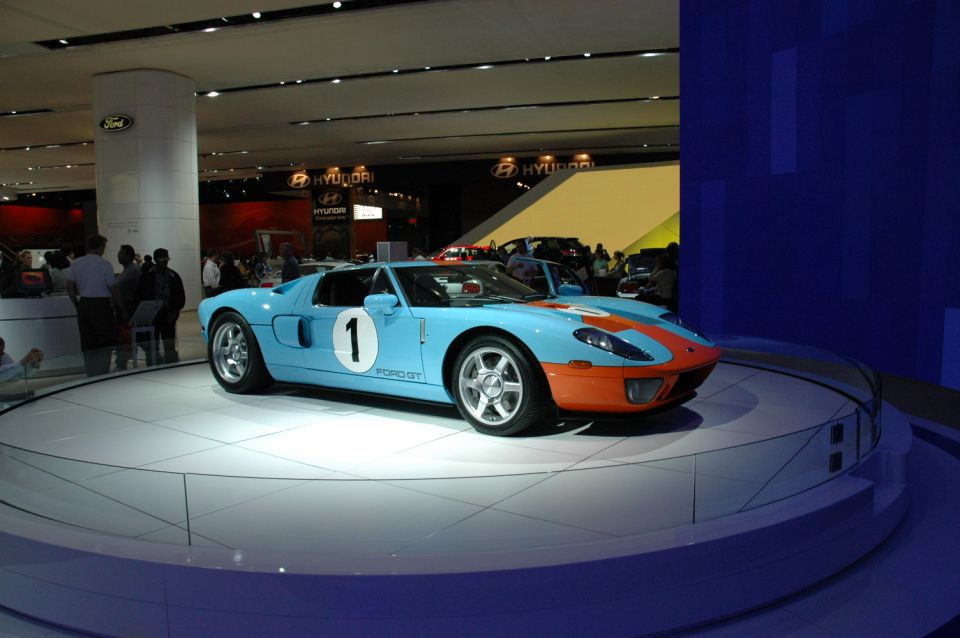 Light blue and orange race car with number 1 on door and 'FORD GT' text