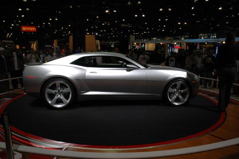 2005 Ford Mustang - A silver coupe is displayed on a rotating platform at an auto show.