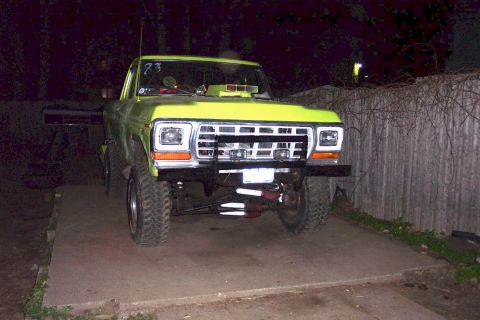 1978 Ford Bronco - Front view of a yellow pickup truck with aftermarket modifications.