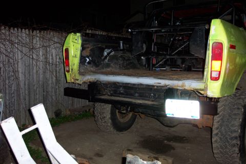 1978 Ford Bronco - Custom rollcage installed in the bed of a lime green pickup truck, viewed from the rear.