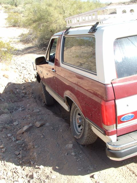 1990 Ford Bronco - The Ford Bronco navigates a rocky, off-road path, its capability.