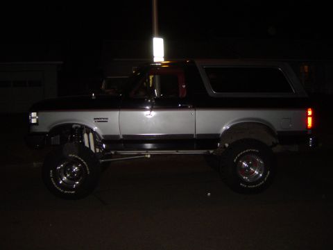 1989 Ford Bronco - Side profile of a lifted 1989 Ford Bronco with custom suspension components visible.