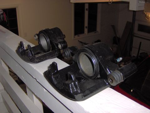 1993 Ford Probe - Two black brake calipers are displayed on a white railing, with a red car visible in the background.